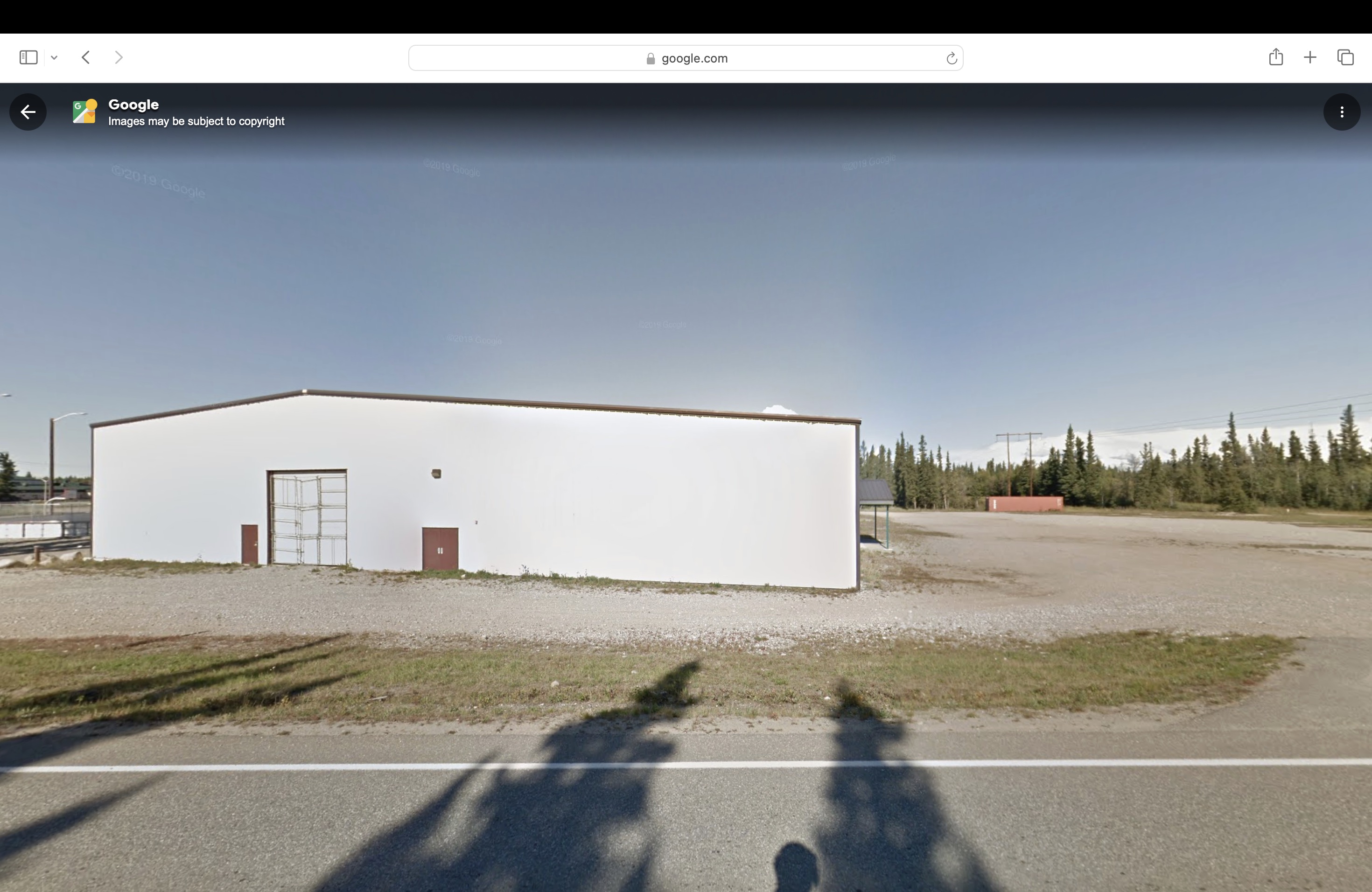 Liewer-Olmstead Ice Arena exterior, with white siding and brown doors.